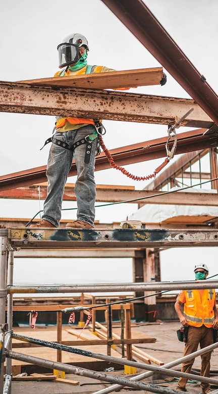 Construction workers building a structure with precision and safety equipment